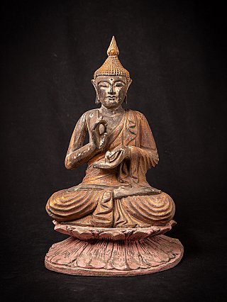 Thai wooden Buddha statue seated on a lotus base, full front view