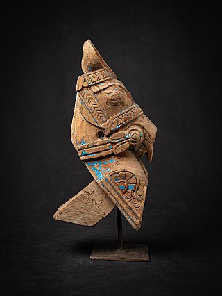 Antique wooden temple fragment with horse head from India, blue paint traces, angled view
