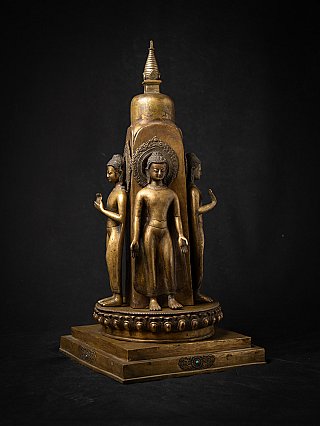 Bronze stupa from Nepal with four standing Buddha statues, three-quarter view on base