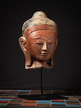 Antique Buddha head from Burma (Myanmar) on stand, three-quarter right view