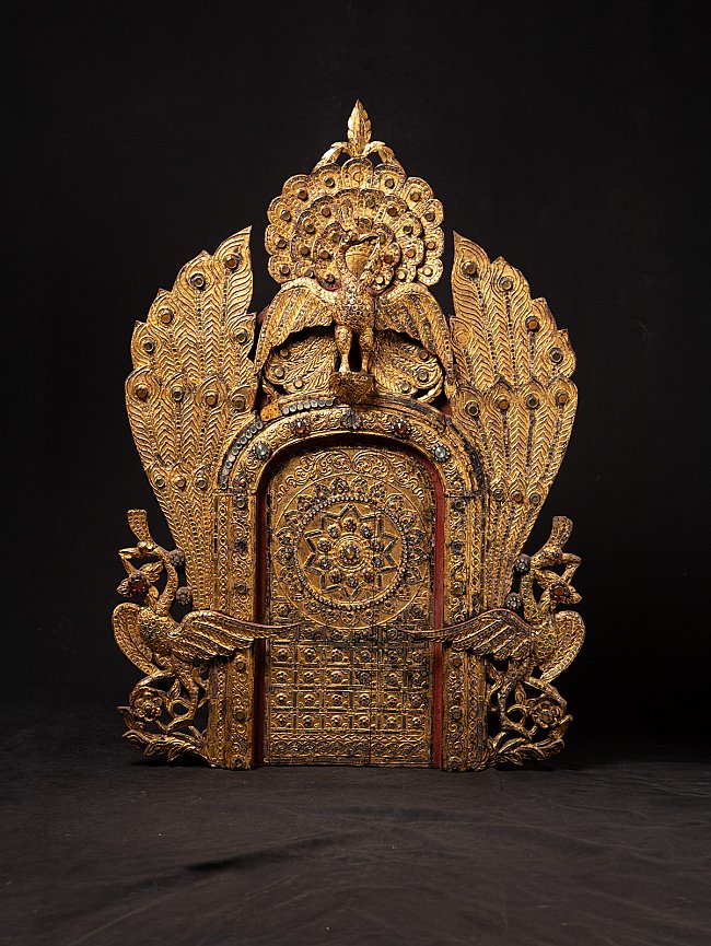 Antique Burmese wooden temple panel with gilded peacock and ornate shrine arch, front view