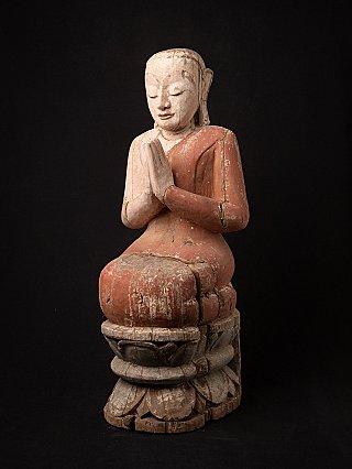 Wooden monk statue from Myanmar with hands in namaskara, three-quarter left view