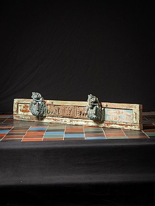 Antique Indian wooden temple panel with two horse heads, angled full view