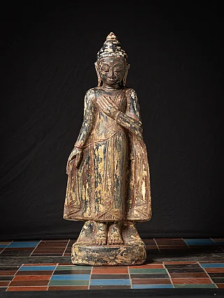 Antique sandstone standing Burmese Buddha