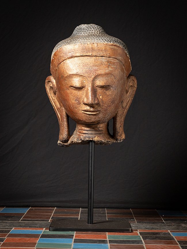 Antique Burmese Buddha head, full front view on metal stand