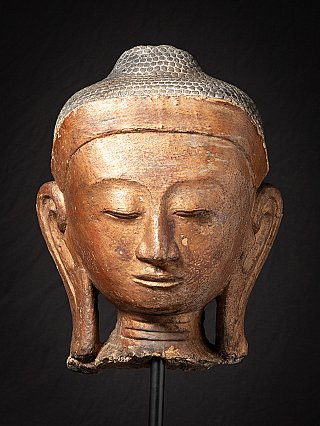 Front close-up of the Burmese Buddha head with elongated earlobes