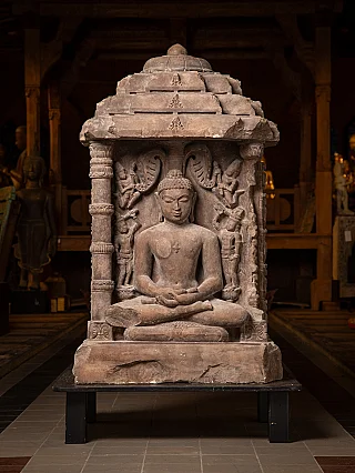 Sandstone Chaumukha altar sculpture from India with seated figure, full front view