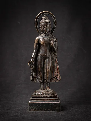 Old bronze standing Nepali Buddha statue