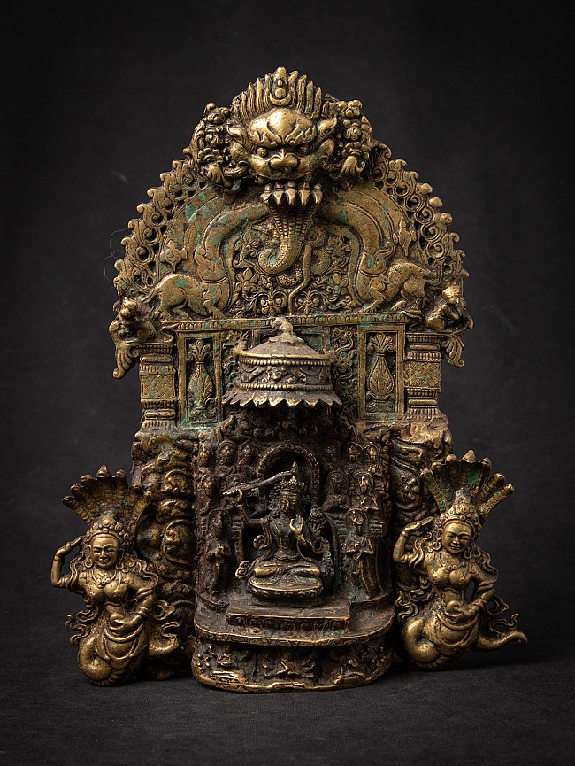 Nepalese bronze altar with Manjushri in the shrine niche, makara head above and two flanking figures