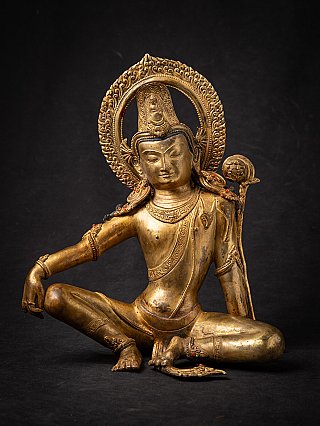 Lokeshvara bodhisattva statue in bronze from Nepal, seated three-quarter view with halo