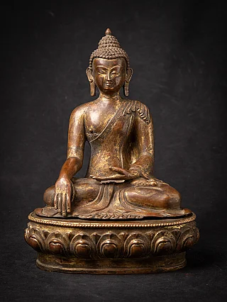 Nepali bronze Buddha statue seated in bhumisparsha mudra, full front view on lotus base