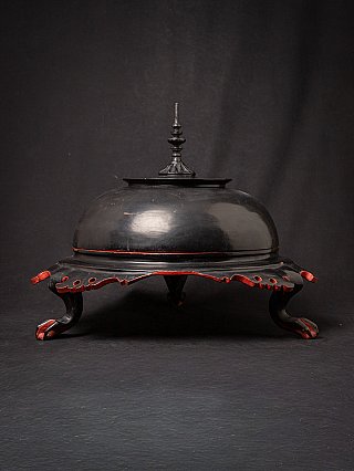 Antique Burmese lacquerware offering vessel with lid, black with red accents, angled view