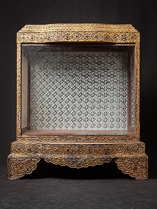 Antique wooden Burmese Buddha temple with glass front and gilded frame, full front view
