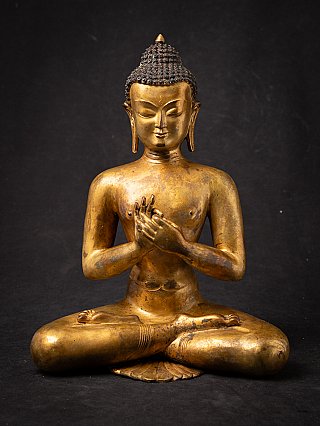 Buddha statue from Nepal in bronze, seated with dharmachakra mudra, full front view
