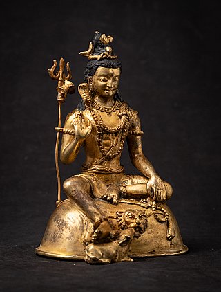 Nepali bronze Shiva statue seated with raised hand, three-quarter front view