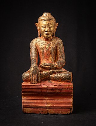 Antique wooden Burmese Buddha statue seated in bhumisparsha mudra, full front view