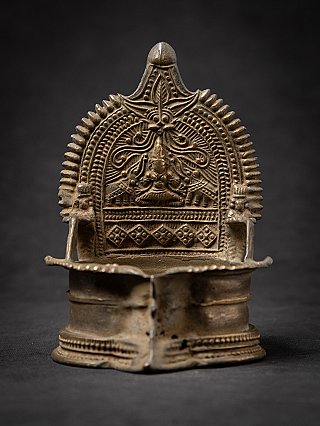 Antique Indian oil lamp (19th century) with relief backplate and spout, front view