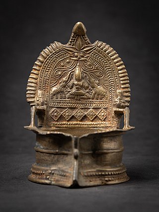 Antique Indian oil lamp, 19th century, with relief backplate, full front view