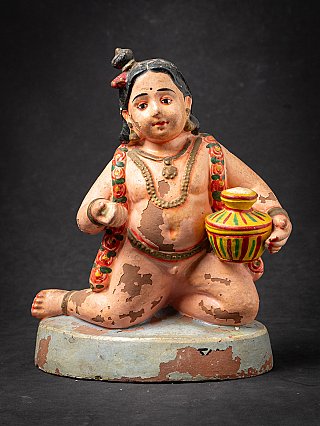 Krishna child statue in painted wood, seated holding a striped pot, full front view