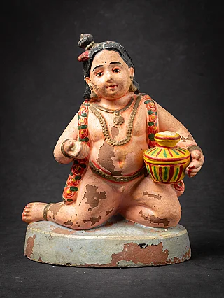 Antique pottery statue of Krishna as a child