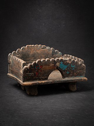 Antique wooden Indian altar, three-quarter view with arched opening and blue paint traces