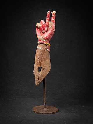 Antique wooden arm of a Hindu god from India, full view with red painted hand on stand