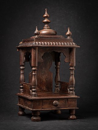 Wooden Indian temple shrine with open niche and drawer, three-quarter left view