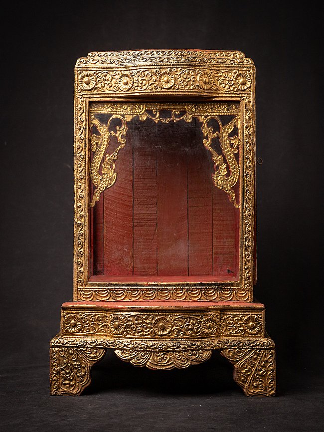 Antique wooden Burmese temple shrine, full front view with gilded frame and red interior