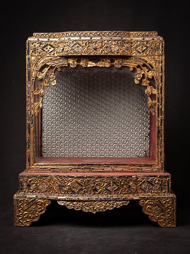 Antique Burmese wooden temple shrine, front view with open niche and gilded ornament