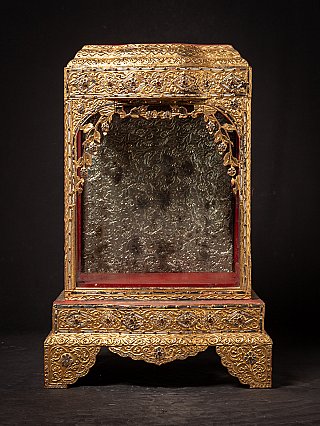 Antique wooden Burmese temple shrine, front view with gilded carved arch