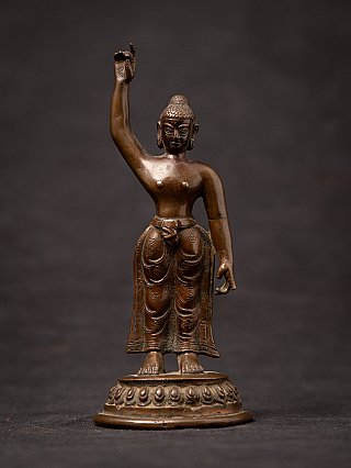 Baby Buddha statue Siddhartha in bronze from Nepal, standing with raised right arm, full front