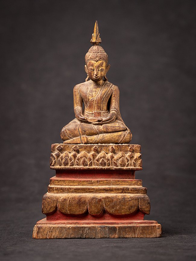 Thai wooden Buddha statue seated in dhyana mudra on stepped base, full front view