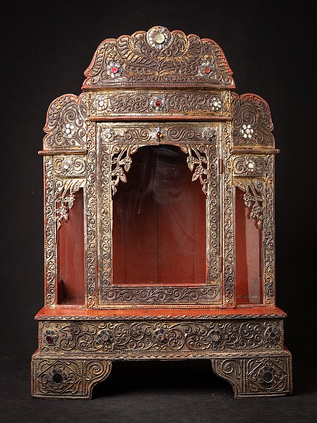 Antique wooden Burmese Buddha temple, full front view with open niche and ornate carving