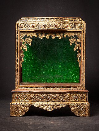 Antique wooden Burmese temple shrine with gilded frame and green interior, front view
