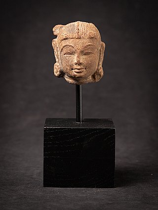 Apsara statue head from India on a metal mount and black wooden base, frontal view