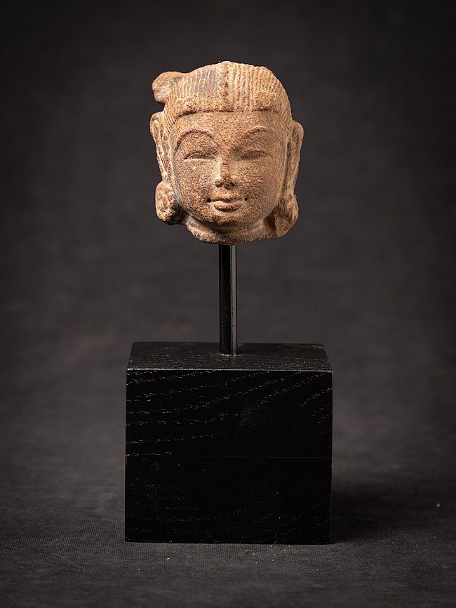 Apsara statue head from India on a metal mount and black wooden base, frontal view