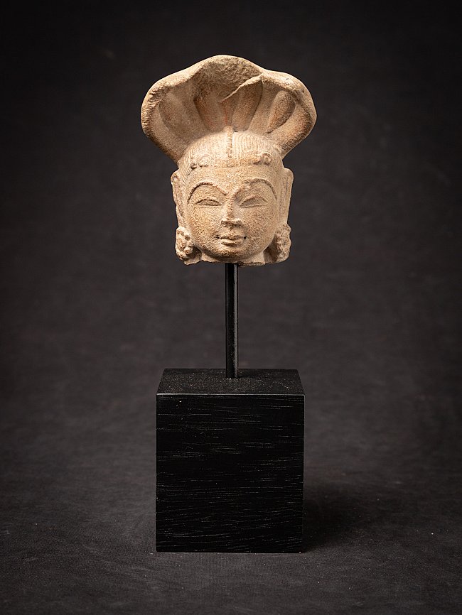 Head of an Indian Nagini statue on a stand, full front view with cobra hood