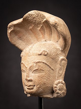 Antique sandstone head of a Nagini statue