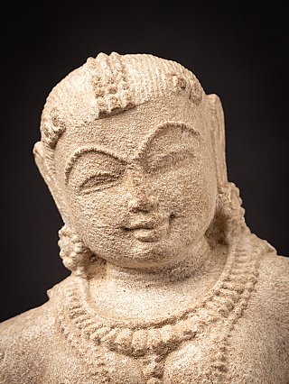 Old sandstone Apsara statue