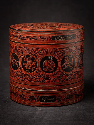 Antique Burmese lacquerware betelnut box with red incised scrolls and round medallions, side view