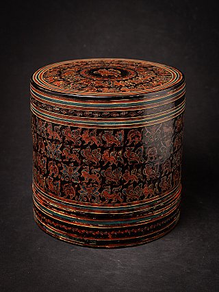 Burmese lacquerware betelnut box with lid, black with red-blue incised decoration, three-quarter view
