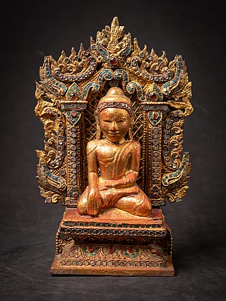 Antique wooden Burmese Buddha on throne