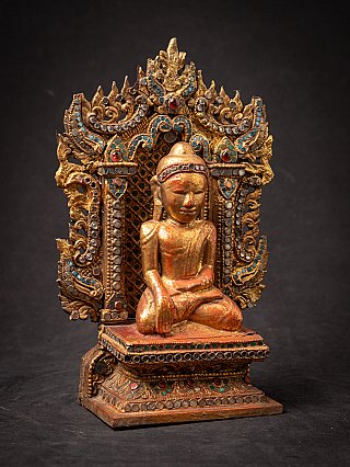 Antique wooden Burmese Buddha on throne