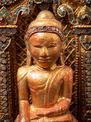 Antique wooden Burmese Buddha on throne