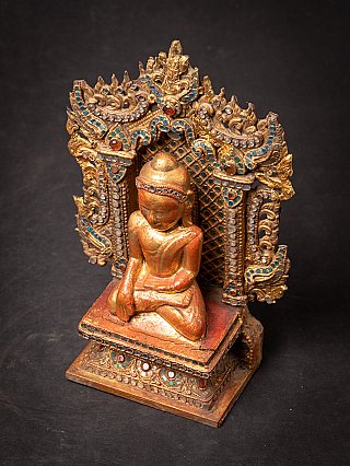 Antique wooden Burmese Buddha on throne
