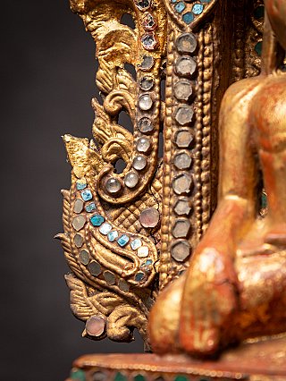 Antique wooden Burmese Buddha on throne