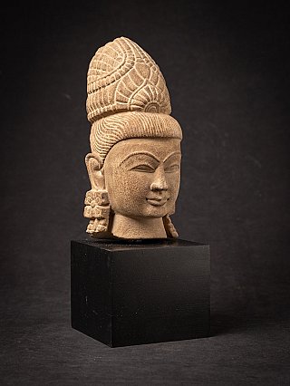 Vishnu head on base, three-quarter view with facial features and carved crown