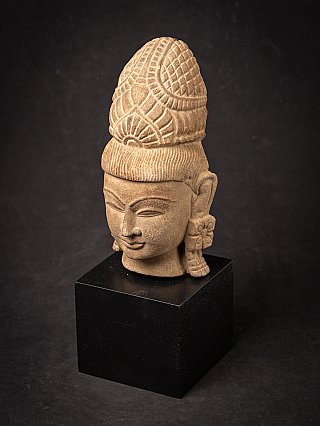 Vishnu head on black base, higher angle view showing crown and face