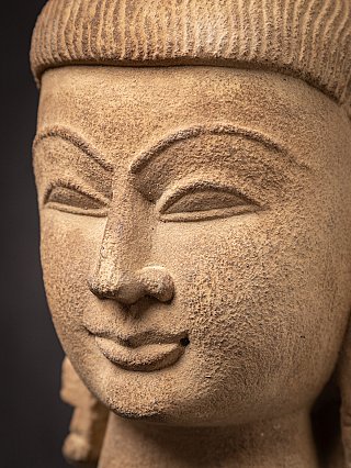 Close-up of the Vishnu face showing nose and mouth with visible stone texture