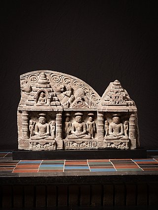 Antique Indian Jain stone panel with three seated figures in niches, full front view